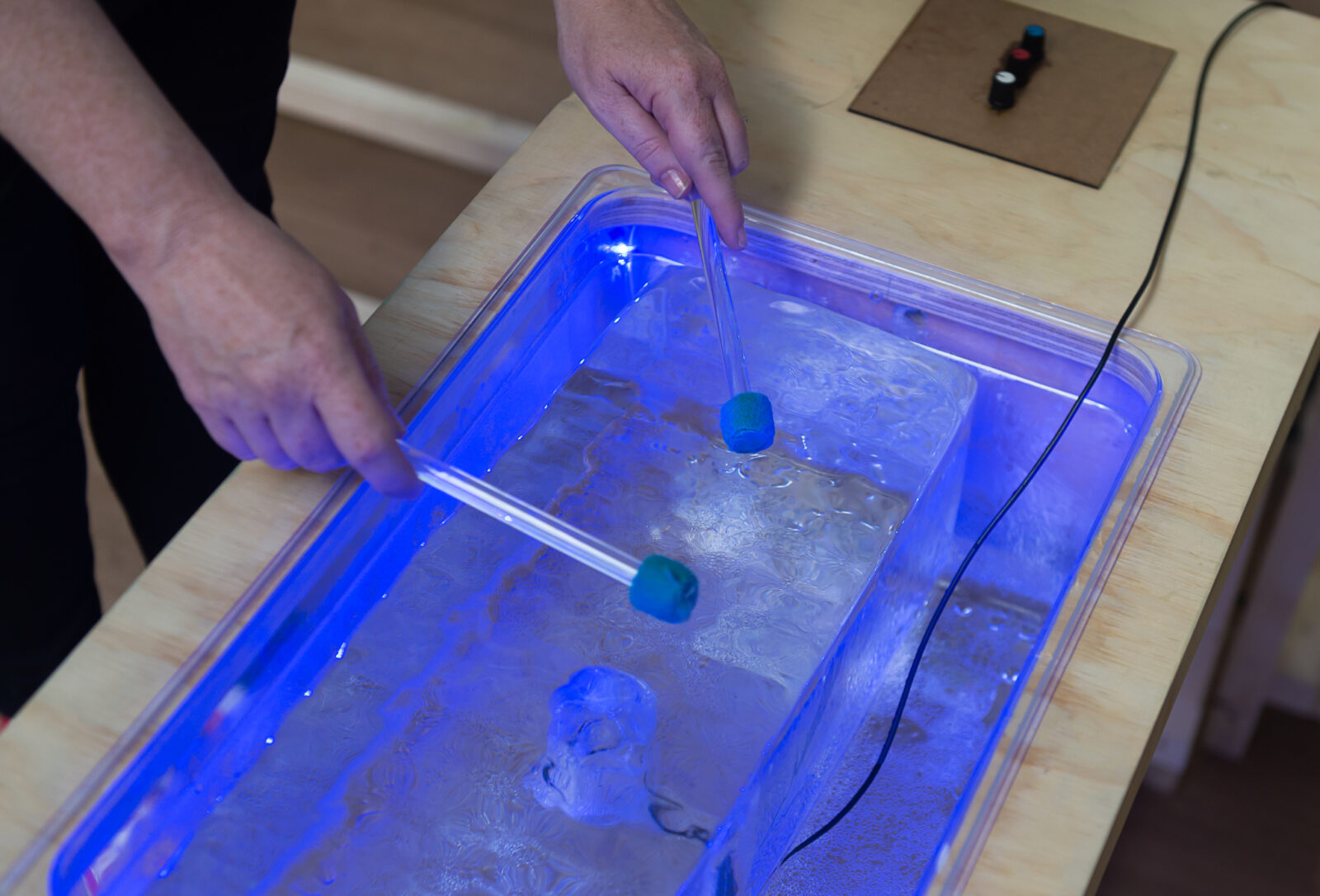 Invisible Flock demonstrate elements of the interactive technology that will be on display in Toxteth Reservoir as part of Aurora. Summer Social: Aurora & Arrival City at Toxteth Town Hall, July 2018. Photo by Brian Roberts.