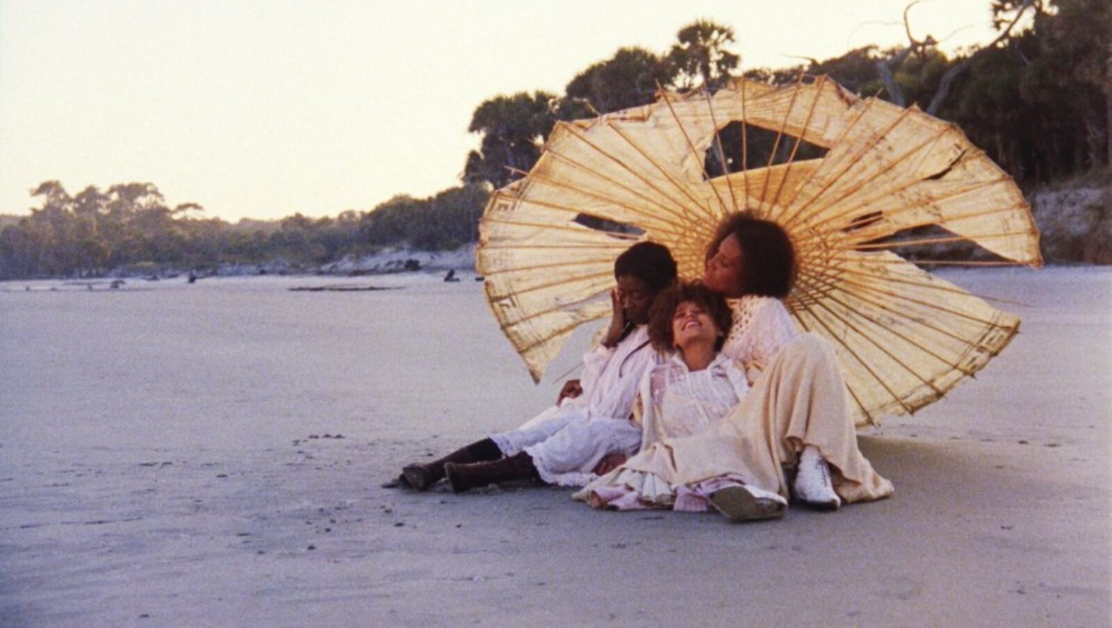 Daughter of the dust 1991 002 women under parasol on beach full shot